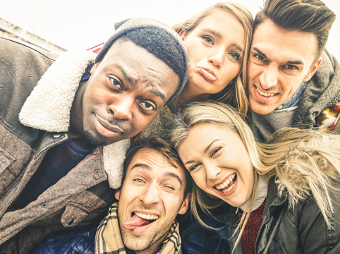 group of people making silly faces for a selfie