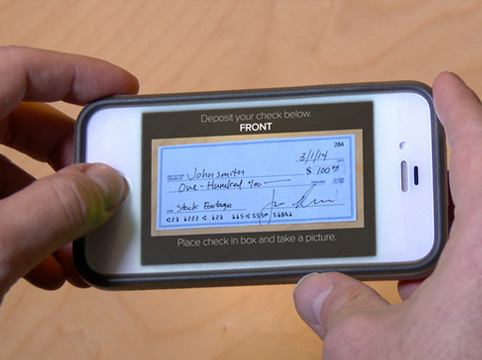 man using his smart phone to make a remote deposit