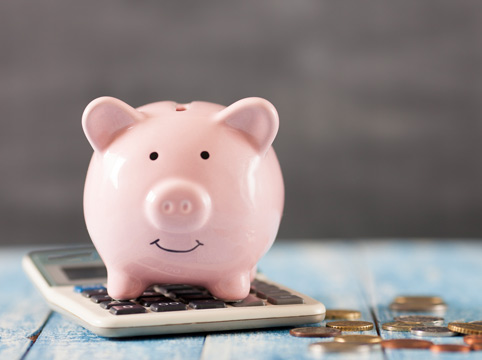 piggy bank with coins and a calculator